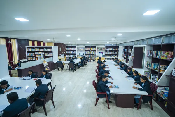 School library with long study tables and reference shelves.