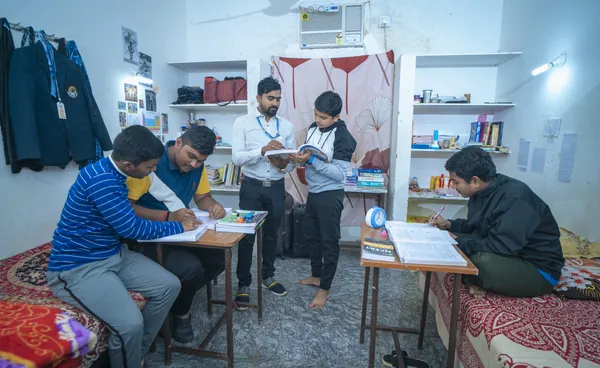 A warden checking in on boarders during study time.