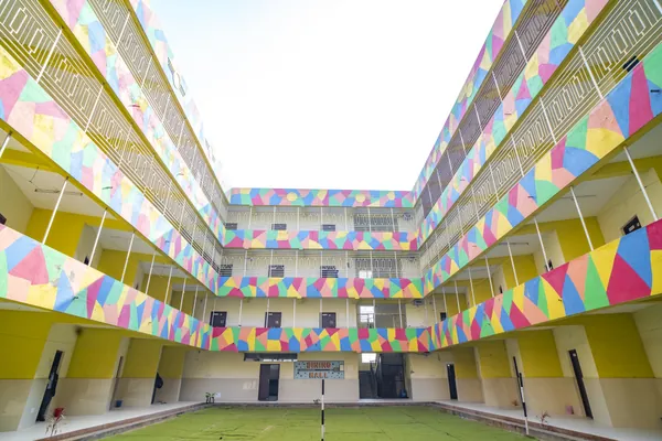 Multi-tiered hostel courtyard leading to the dining hall.